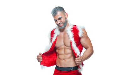 Sexy Santa Claus. Bodybuilder young handsome santa clause smile shows off abs cubes at New Years eve and Christmas winter holiday white background