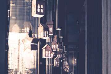 Decorations in the form of glowing lanterns on the window of the cafe. Christmas decorations. Background. Copy space.