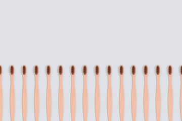 Frame made of toothbrushes on a blue background. Zero waste composition with copy space.