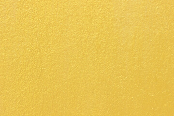 golden or yellow paint on cement wall texture background.