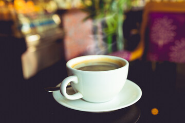 Hot black coffee on table in cafe