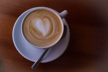 A Cup of coffee, a heart made of coffee foam.