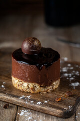 Chocolate cupcake on a wooden cutting board in rustic style