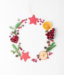 Christmas Decorative Border made of Festive Elements, gingerbread cookies, cranberries on white wooden background.