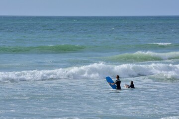 People practising surf on a beach in Brittany. France