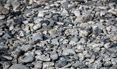  Grey Pebbles on the beach on ocean. Selective focus