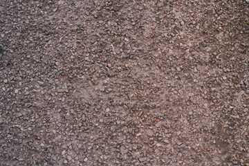 Background of small stones, gravel on the cement. Stone brown background.