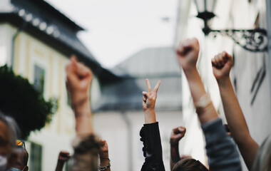 Arms and fists raised in the air, protest and demonstration concept.