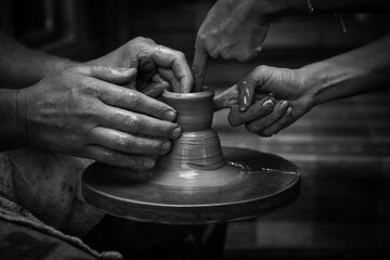 the image of the male hands of an artisan that sculpts from clay