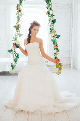 Fototapeta premium Wedding day and beautiful bride in studio. Beautiful young bride with wedding makeup and hairstyle. Portrait of young gorgeous bride. Wedding.