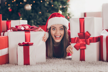 Close-up portrait of her she nice attractive lovely charming glad cheerful cheery girl lying on carpet floor among pile stack many giftboxes December sale in light house interior indoor