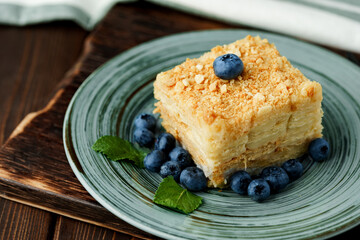 Piece of cake Napoleon on green plate