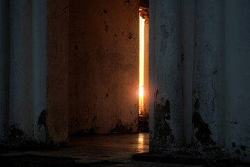 Sun light shining through the gap of the dark abandoned building interior