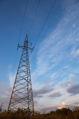 high voltage pylons against the background of blue sky