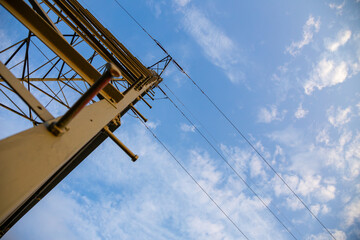 insulators on high-voltage pylons against the background of blue sky