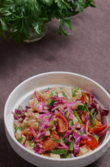fresh vegetable salad in a white plate on the table