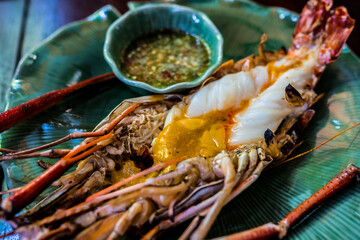 Thai cuisine food, grilled prawns with spicy sauce close up