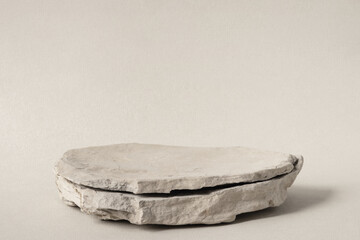 Background for cosmetic products of natural gray color. Stone podium on a gray background. Front...