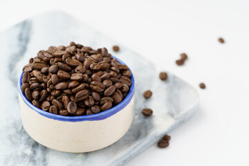 Coffee beans in a bowl with blue rim
