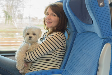 Dog traveling by train with his owner © Monika Wisniewska