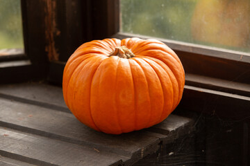 Pumpkin in a village house. Against the background of the window.
