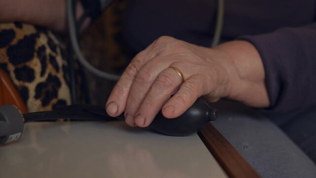 Blood pressure measurement by an elderly woman, close-up.