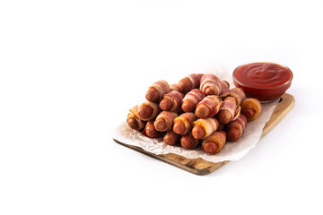 Pig in blankets. Sausages wrapped in smoked bacon isolated on white background.Copy space