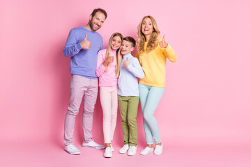 Full length photo of positive family mom dad and two small kids show thumb up sign isolated on pastel color background