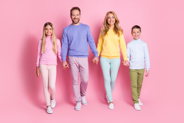 Obraz premium Full size photo of positive family daddy mommy small boy girl hold hand go isolated over pastel color background