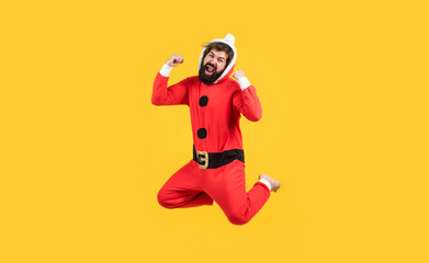 Be happy. jumping bearded man in christmas costume. concept of freedom. happy male has funny look. winter holiday party. new year fun. santa ctlaus in hat hurry up to xmas shopping sales