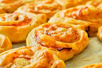Fresh puff pastry rolls on baking tray