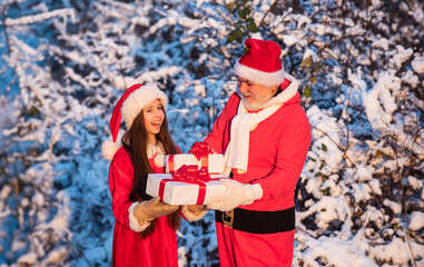 Fototapeta na wymiar Frosty christmas morning. Santa and granddaughter. Time for miracles. Generous Santa Claus. Child happy girl outdoors snowy nature. Merry christmas. Happy childhood concept. Gifts from Santa