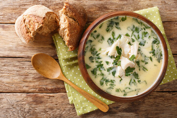 Homemade scotch milk soup cullen skink with smoked haddock and potatoes close-up in a bowl on the table. Horizontal top view from above