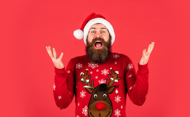 new year party. surprise for xmas holiday. gifts and presents preparation. its christmas time. happy bearded man in sweater. mature and brutal hipster in santa claus hat