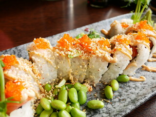 California roll sushi lunch with edamame beans, chili mayonnaise, white roe and seaweed