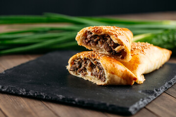 Cut oriental dish baked pie with meat samsa