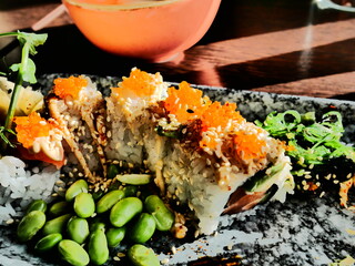 California roll sushi lunch with edamame beans, chili mayonnaise, white roe and seaweed