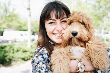 Young girl smiling as she hugs her adorable dog.Love for animal concept.