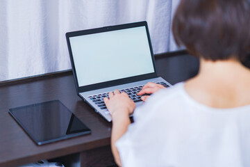 Japanese middle aged woman works online at hotel