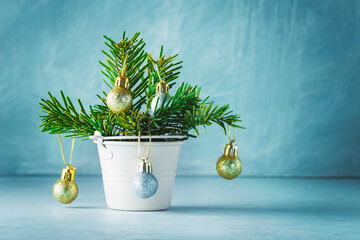 Christmas tree branches in a small metal bucket