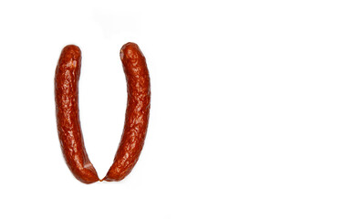 Creative layout of pinkel, a smoked kaszanka sausage, Cabanossi isolated on white background. Food concept. Flat lay and copy space for text