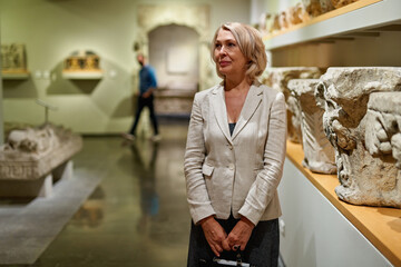 Woman exploring medieval expositions in museum
