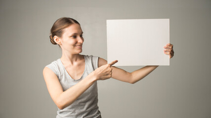 Fototapeta na wymiar woman holding a sheet of paper in her hand