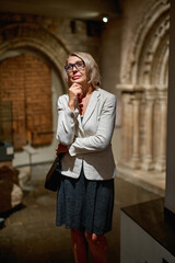 Mature woman visiting antique museum