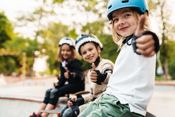 Fototapeta na wymiar Happy cheerful kids with skateboards at the ramp