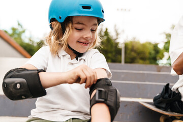 Young girl skateboarder wearing helmet