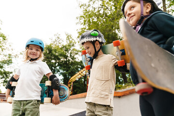 Happy cheerful kids with skateboards at the ramp © Drobot Dean