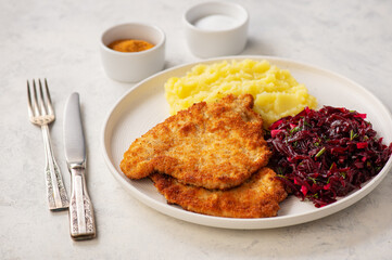 Chop pork cutlets , served with mashed potatoes and beetroot salad.