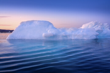 floating glaciers in the rays of the setting sun at polar night