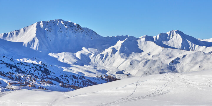 Panoramic view of the snowy high-altitude mountain range near the  Tignes ski resort in France during the winter season.